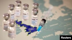  Vials labelled "COVID-19 Coronavirus-Vaccine" and a medical syringe are seen placed on the European Union map in this picture illustration taken December 2, 2020.