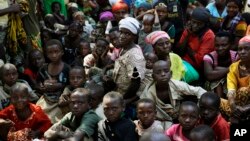 FILE - Refugees who fled Burundi's violence and political tension wait to board a U.N. ship, at Kagunga on Lake Tanganyika, Tanzania, to be taken to the port city of Kigoma, May 23, 2015.