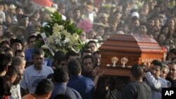 Mourners carry the coffin of slain mayor of Temixco, Gisela Mota, to the cemetery in Pueblo Viejo, Mexico, Sunday, Jan. 3, 2016. A new study suggests that Mexico's drug violence was so bad at its peak that it apparently caused the nation's male life expec