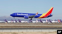 In this March 23, 2019, photo, a Southwest Airlines Boeing 737 Max aircraft lands at the Southern California Logistics Airport in the high desert town of Victorville, Calif. Southwest, which has 34 Max aircraft, is making cancellations five days in advance.