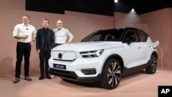 Henrik Green, left, Chief Technology Officer of Volvo said the company would stop selling vehicles powered by traditional engines by 2030. (AP Photo/Michael Owen Baker)