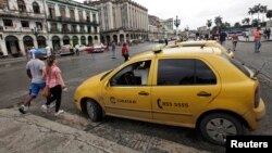 A taxi driver awaits customers in Havana, Cuba, Jan. 8, 2014. 