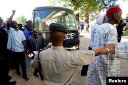 FILE - Gambian political prisoners arrive at the Supreme Court for trial in Banjul, Gambia, Dec. 5, 2016.