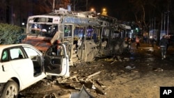 Damaged vehicles are seen at the scene of an explosion in Ankara, Turkey, Sunday, March 13, 2016.