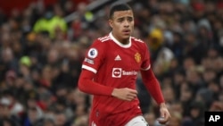 FILE- Manchester United's Mason Greenwood runs during an English Premier League soccer match between Manchester United and Burnley, at Old Trafford in Manchester, England, Dec. 30, 2021. 
