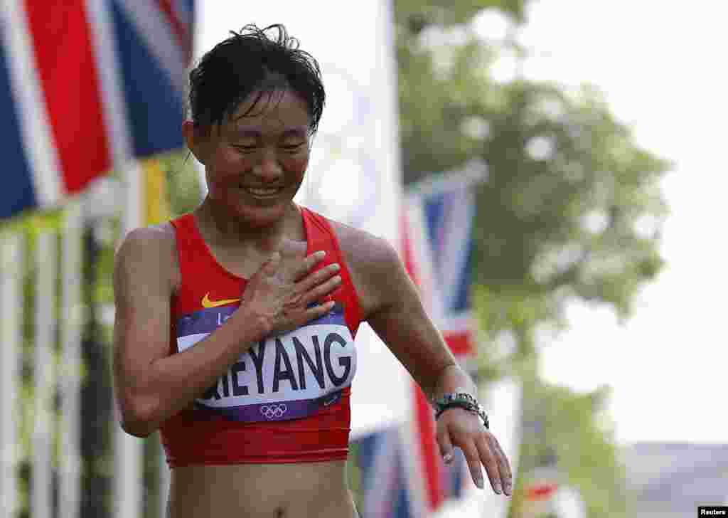 Choeying Kyi smiles as she finishes third in the women&#39;s 20km race walk final at the London 2012 Olympic Games at The Mall August 11, 2012