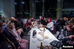 Refugees in Iceland who were invited to attend a New Year's Eve party, are seen at Reykjavik city hall, Iceland, Dec. 31, 2016.