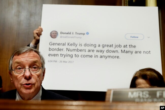 Sen. Dick Durbin, D-Ill., ranking Member of the Senate Committee on the Judiciary, Subcommittee on Border Security and Immigration, speaks while a staffer holds up a Twitter quote by President Donald Trump, during a subcommittee hearing about the border.