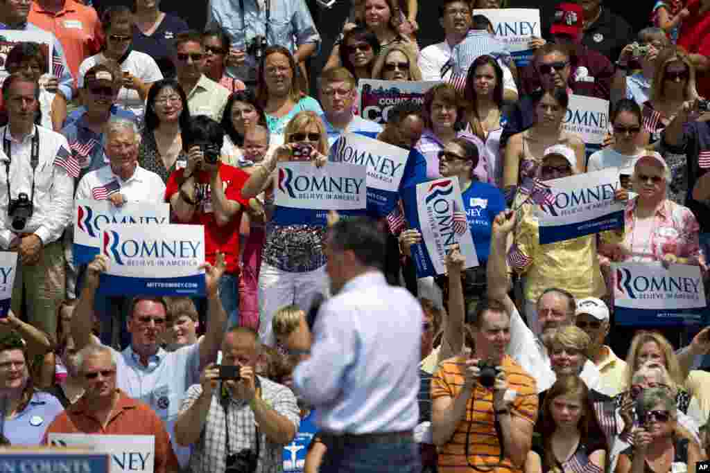 Supporters of Republican presidential candidate Mitt Romney watch him speak at a campaign stop in front of the Licking County Court House in Newark, Ohio, June 17, 2012