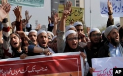 FILE - Pakistani students of Islamic seminaries chant slogans during a rally in support of blasphemy laws, in Islamabad, Pakistan, March 8, 2017. Hundreds of students rallied in the Pakistani capital, Islamabad, urging government to remove blasphemous content from social media and take stern action against those who posted blasphemous content on social media.