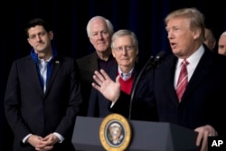 President Donald Trump, accompanied by from left, House Speaker Paul Ryan of Wis., Senate Majority Whip Sen. John Cornyn, and Senate Majority Leader Mitch McConnell, speaks to members of the media at Camp David, Jan. 6, 2018.