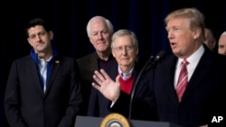 FILE - President Donald Trump, accompanied by from left, House Speaker Paul Ryan of Wisconsin, Senate Majority Whip John Cornyn of Texas and Senate Majority Leader Mitch McConnell of Kentucky, speaks to reporters at Camp David, Jan. 6, 2018. 
