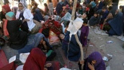 Internally displaced Afghan women from northern provinces, who fled their home due to fighting between the Taliban and Afghan security personnel, receive medical care in a public park in Kabul, Afghanistan, Tuesday, Aug. 10, 2021. (AP Photo/Rahmat Gul)