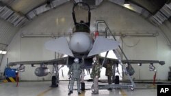 An Italian pilot and ground crew check a Eurofighter EF-2000 Typhoon at the Gioia del Colle NATO Airbase in Italy, March 21, 2011. Arab nations do not want military intervention under way in Libya to be placed under NATO control, said French Foreign Minis