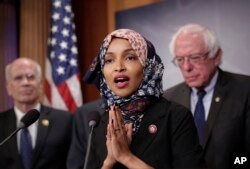 FILE - Representative Ilhan Omar, Democrat-Minnesota, center, is seen with fellow lawmakers during a news conference on Capitol Hill in Washington, Jan. 10, 2019.