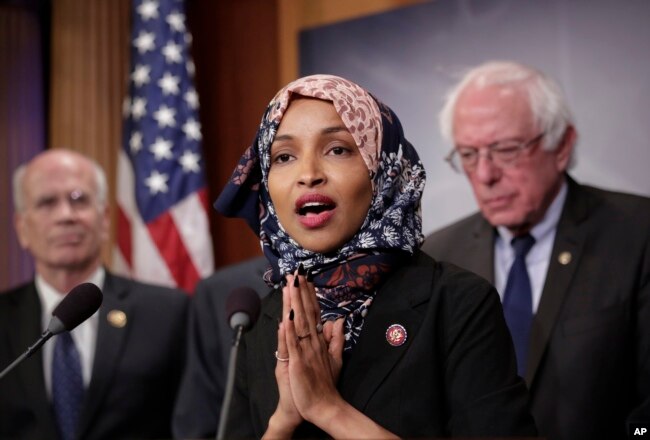 FILE - Representative Ilhan Omar, Democrat-Minnesota, center, is seen with fellow lawmakers during a news conference on Capitol Hill in Washington, Jan. 10, 2019.