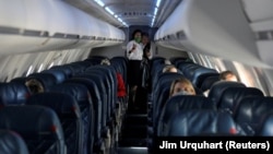 FILE - Passengers fly in a nearly empty cabin amid concerns of the coronavirus disease (COVID-19), during a Delta Airlines flight departing from Salt Lake City, Utah, U.S. April 11, 2020. (REUTERS/Jim Urquhart/File Photo)