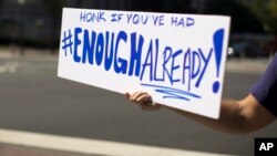 A furloughed federal worker, who did not wish to be identified, holds out a sign to passing traffic on Pennsylvania Avenue in Washington, D.C., Oct. 2, 2013. 