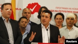 Macedonian Social Democratic leader Zoran Zaev, center, and members of his party attend a news conference in Skopje, Macedonia, April 28, 2017, a day after protesters attacked parliament. 