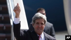 U.S. Secretary of State John Kerry flashes the thumbs-up sign as he arrives at Manila's International Airport, Philippines on Tuesday, Dec. 17, 2013. 