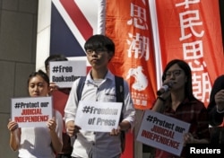 FILE - Members of student group Scholarism protest the disappearance of booksellers outside the British consulate in Hong Kong, Jan. 6, 2016.