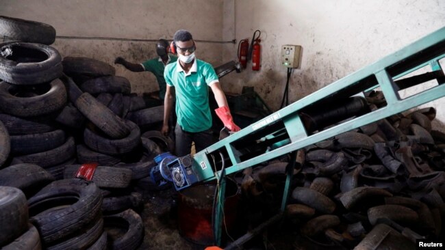 A man works on the recycling line of used car tires at the Freetown waste management recycle factory in Ibadan, Nigeria Sept. 17, 2021.