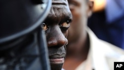 Uganda's Forum for Democratic Change leader Kizza Besigye is arrested by anti-riot policemen at the Kasangati suburb of Kampala, April 14. (Reuters)