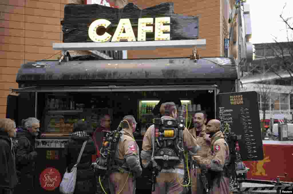 Members of a German Ghostbusters fanclub dressed as the film's characters, drink coffee at a street food market at the 66th Berlinale International Film Festival in Berlin, Germany.