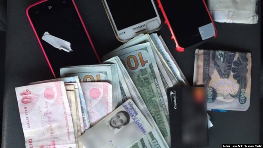 Items taken from an American identified as Mohamed Jamal Khweis, suspected of being a member of the Islamic State group, who is now in custody of Kurdish Peshmerga forces in northern Iraq.