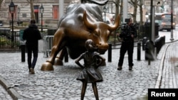 FILE - Wall Street ‘Charging Bull’ sculptor wants the ‘Fearless Girl’ statue removed.