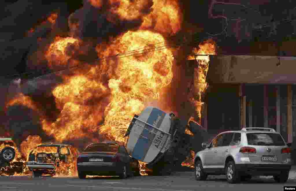 Burning vehicles are seen at the site of a fire in Almaty, Kazakhastan. A 16-ton tanker rolled over after an accident and set ablaze parked cars and a nearby apartment building, Emergency Ministry reported.