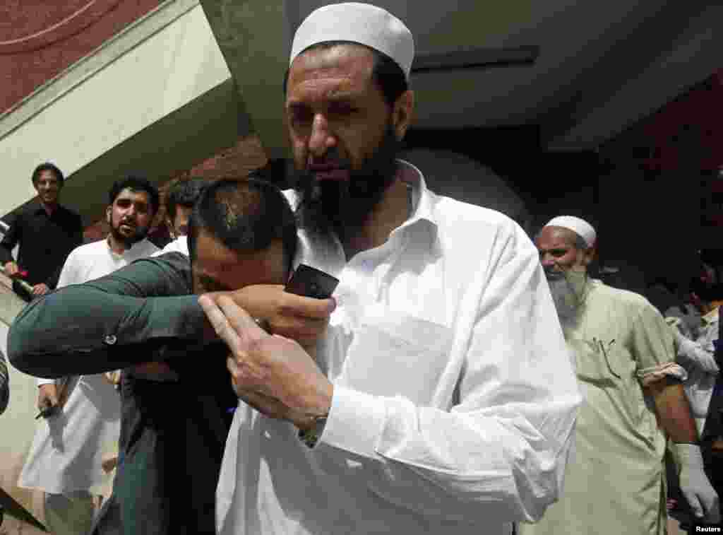 A man weeps over the death of his brother who was a victim of the bomb blast, April 29, 2013. 
