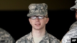 In this file photo taken Dec. 22, 2011, Army Pfc. Bradley Manning is escorted from a courthouse in Fort Meade, Maryland. 