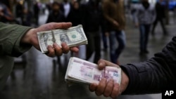 Iranian street money exchangers show currencies at Tehran's old main bazaar, Iran, Nov. 25, 2014.