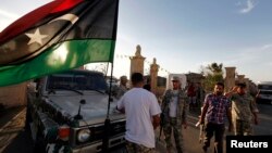 Libyan security forces evict an armed group from a compound in Tripoli, Sept. 23, 2012.