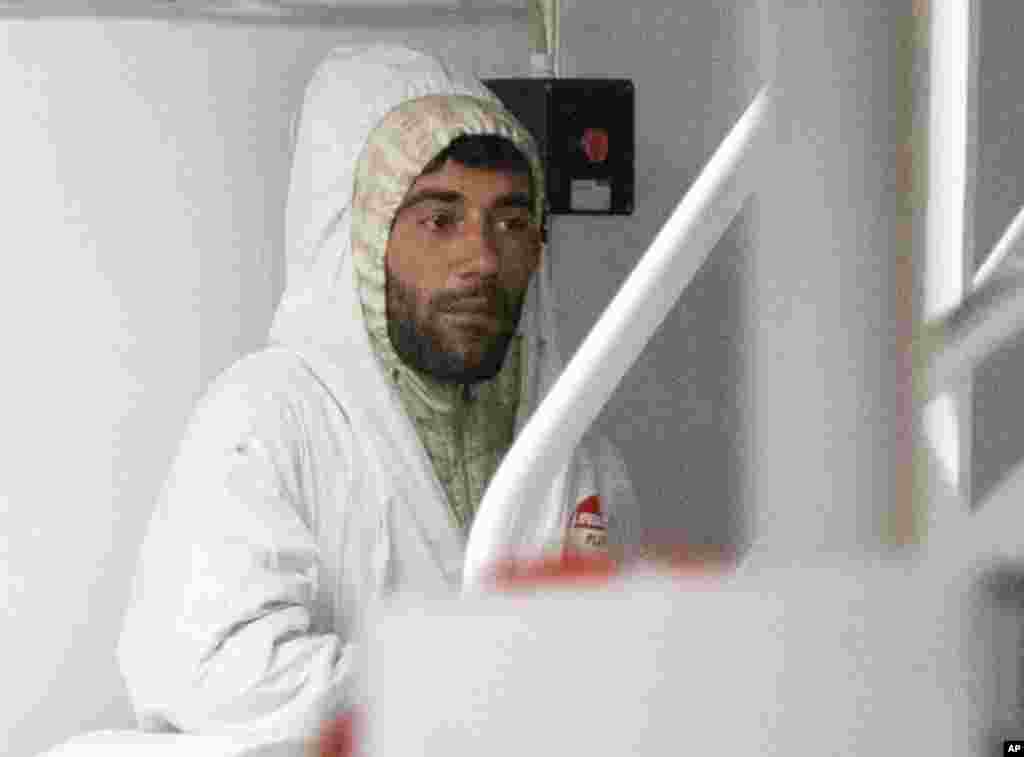 Tunisian Mohammed Ali Malek, at the time this photo was taken, was not identified as the captain of the sunken vessel. He waits to disembark from the Italian Coast Guard ship Bruno Gregoretti, at the port of Catania, Italy, April 20, 2015.