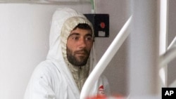 Tunisian captain Mohammed Ali Malek, one of the survivors of the boat that overturned off the coasts of Libya Saturday, waits to disembark from Italian Coast Guard ship Bruno Gregoretti, at Catania Harbor, Italy, April 20, 2015. 