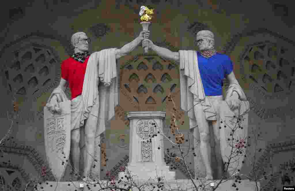 The statues on Bush House, the former headquarters of the BBC, are seen dressed in glasses, scarves and T-shirts by artist Leo Caillard as part of his The Classical Now show at Bush House and Sommerset House, in London.