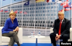 FILE - U.S. President Donald Trump meets with German Chancellor Angela Merkel during the NATO summit in Brussels, Belgium, July 11, 2018.