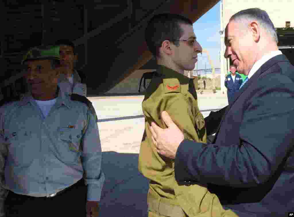 October 18: Israel Prime Minister Benjamin Netanyahu greets Gilad Shalit at Tel Nof air base in central Israel. Israeli soldier Shalit returned home on Tuesday after five years in captivity. The hundreds of Palestinian prisoners exchanged for him were gre