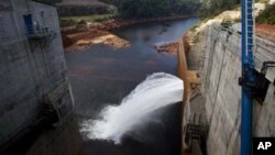 In this photo taken on Oct. 24, 2010, the Nam Theun 2 dam on the Nam Theun river, a tributary of the Mekong river, in central Laos releases water to the river below. 