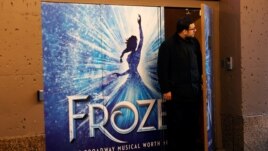 FILE PHOTO: A worker looks out from the closed St James theater where the musical 