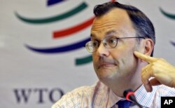 FILE - WTO spokesman Keith Rockwell speaks with reporters at the WTO headquarters in Geneva, May 1, 2006.