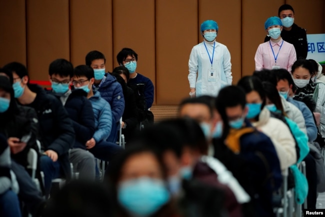People sit at a vaccination site after receiving a dose of a coronavirus disease (COVID-19) vaccine, during a government-organised visit, following the coronavirus disease (COVID-19) outbreak, in Shanghai, China January 19, 2021.