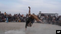 Afghan men wrestle in Kabul, Dec. 3 , 2021. The scene is one played out weekly after Friday prayers in Chaman-e-Huzori park in downtown Kabul, where men, mainly from Afghanistan's northern provinces, gather to watch and to compete in pahlawani, a traditional form of wrestling. 