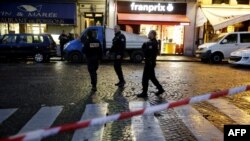 Police stand guard after cordoning off an area in central Paris as security operations continue in the wake of the Nov.13 terror attacks, in which at least 129 people were killed, Nov. 17, 2015.