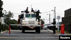 Armored car drives through gate of U.N. base near Quneitra border crossing between Israel and Syria, Israeli-occupied Golan Heights, March 8, 2013.