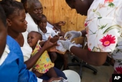 FILE - Victims of cholera receive treatment at the state hospital after Hurricane Matthew, in Jeremie, Haiti, Oct. 8, 2016.