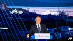 FILE - Russian President Vladimir Putin gestures as he delivers a speech during a plenary session at the Eastern Economic Forum, in Vladivostok, Russia, Sept. 3, 2021.