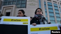 Human rights activists stage a protest outside a court in Istanbul, Jan. 31, 2018, where the trial of eleven human rights activists accused of belonging to and aiding terror groups was held. While the eleven were recently released, Amnesty's Turkey chairman Taner Kilic was re-arrested on Feb.1, 2018. 
